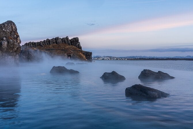 Kopavorgur and Reykjavik's buildings can be seen from the Sky Lagoon.