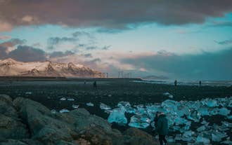 Pieces of ice from Jokulsarlon scattered on the black sands of Diamond Beach.