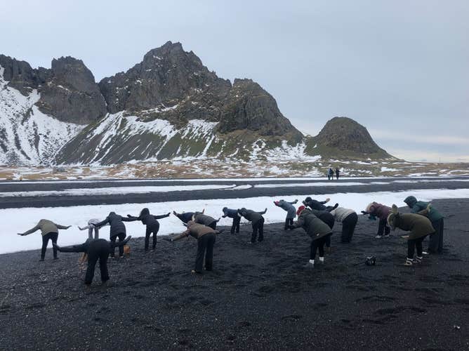 Try out easy yoga poses on the black sands of Hofn bay.