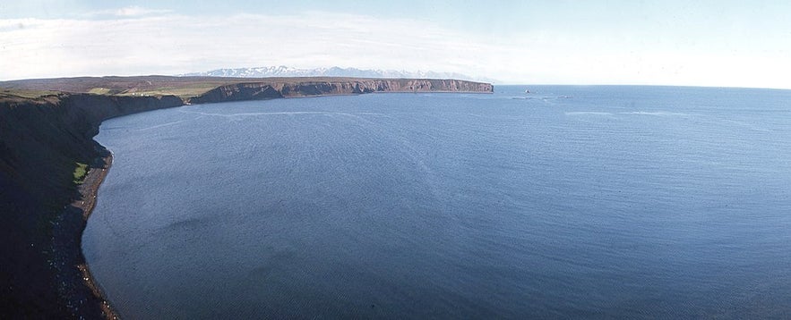 The blue waters of Skjalfandi Bay in North Iceland with mountains in the background.