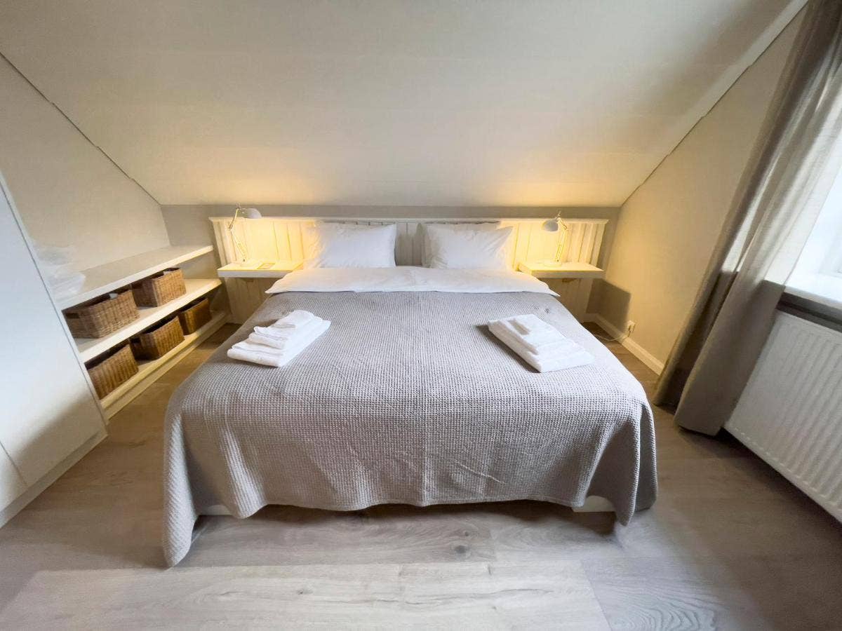 Kristinsson Apartment's bedroom one with a large bed is perfect for couples and pairs.