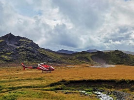 A helicopter makes a landing at Hengill geothermal area.