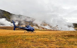 Hot steam rises from the surface as a helicopter lands nearby.