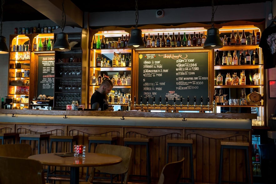 The bar at Skúli Craft Bar in Reykjavik displays a variety of drinks.