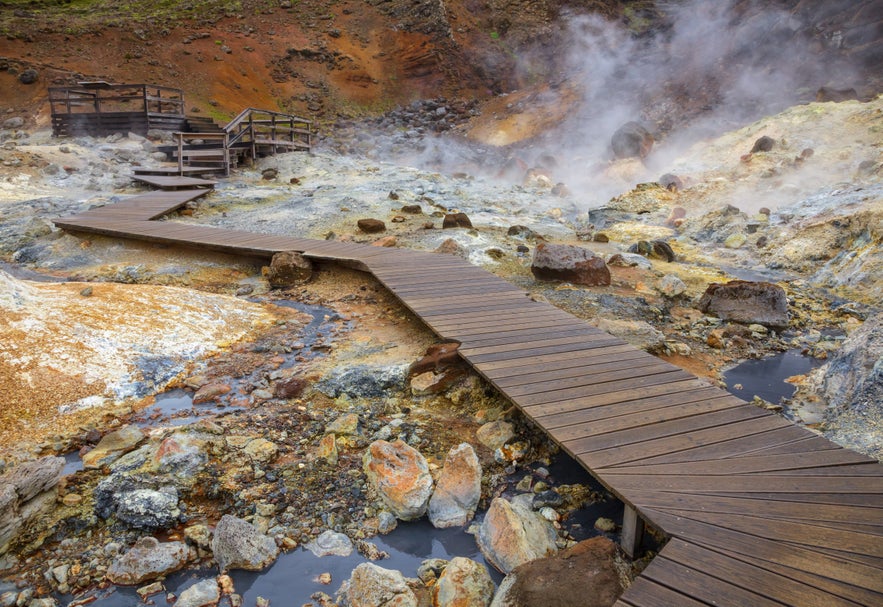 Steaming geothermal landscape with wooden walkways at Krysuvik on the Reykjanes Peninsula.