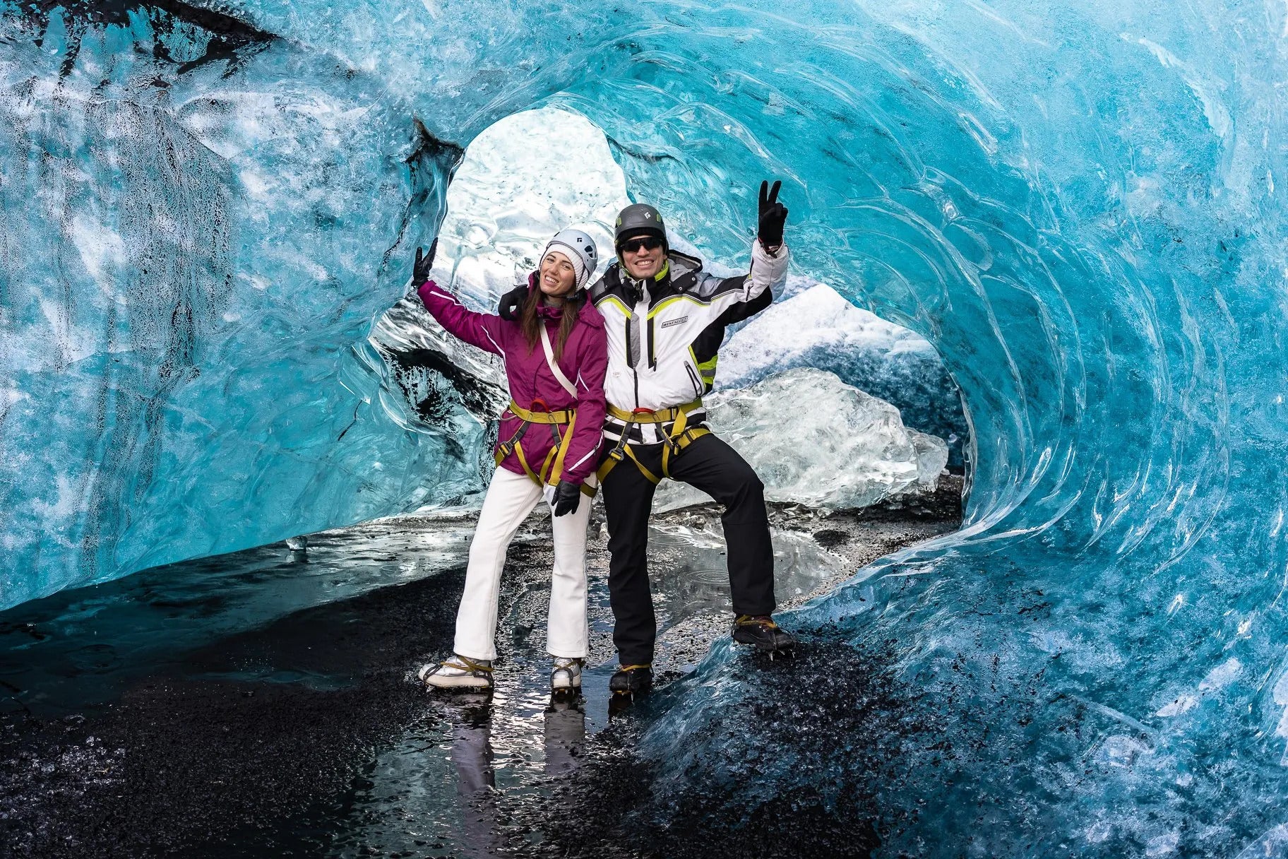 Travelers exploring ice caves on a guided Vatnajokull Glacier hike.