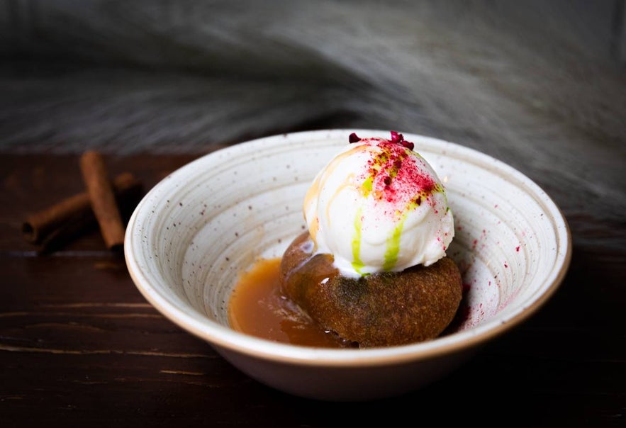 Sticky toffee pudding with vanilla ice cream and berry dust at Tryggvaskali in Selfoss, Iceland. Sticky toffee pudding with vanilla ice cream and berry dust at Tryggvaskali in Selfoss, Iceland.