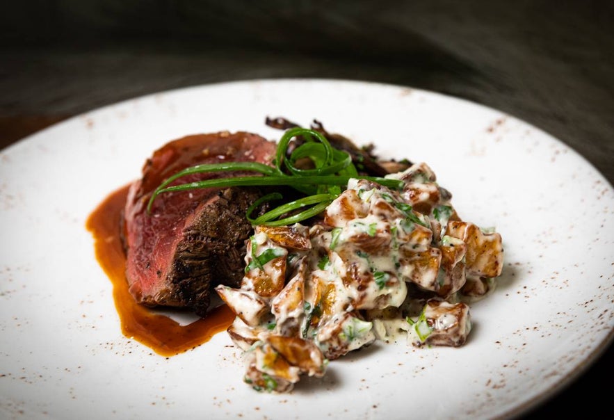 Beef tenderloin with creamy risotto and fresh green garnish at Tryggvaskali in Selfoss, Iceland. Beef tenderloin with creamy risotto and fresh green garnish at Tryggvaskali in Selfoss, Iceland.