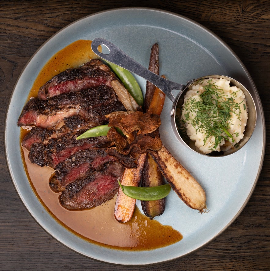 Reverse sear bone-in ribeye with roasted vegetables and a side of mashed potatoes at Lilly & Julia’s – Viking BBQ. Reverse sear bone-in ribeye with roasted vegetables and a side of mashed potatoes at Lilly & Julia’s – Viking BBQ.