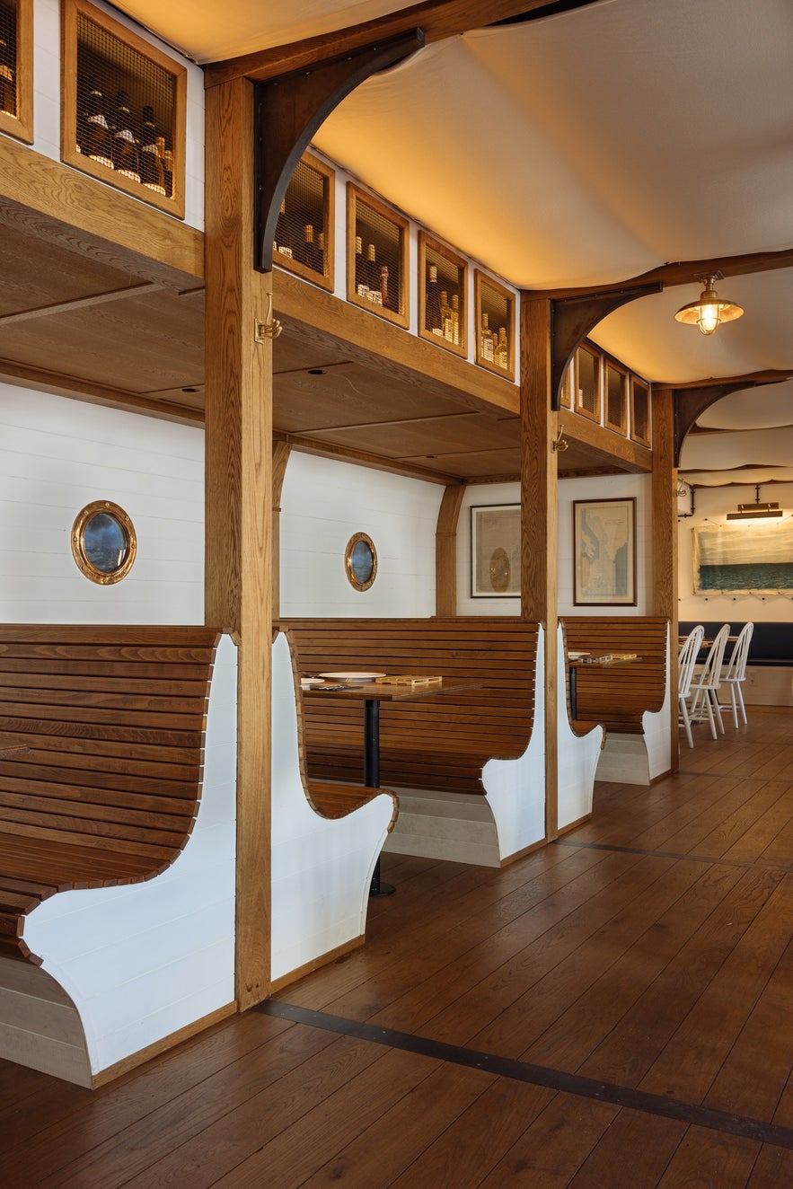 Mar Seafood Restuarant's wooden booths, porthole windows, and nautical inspired decor.