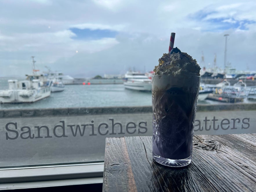View of a blueberry latte from Reykjavik Rost and the Reykjavik Harbor in the background