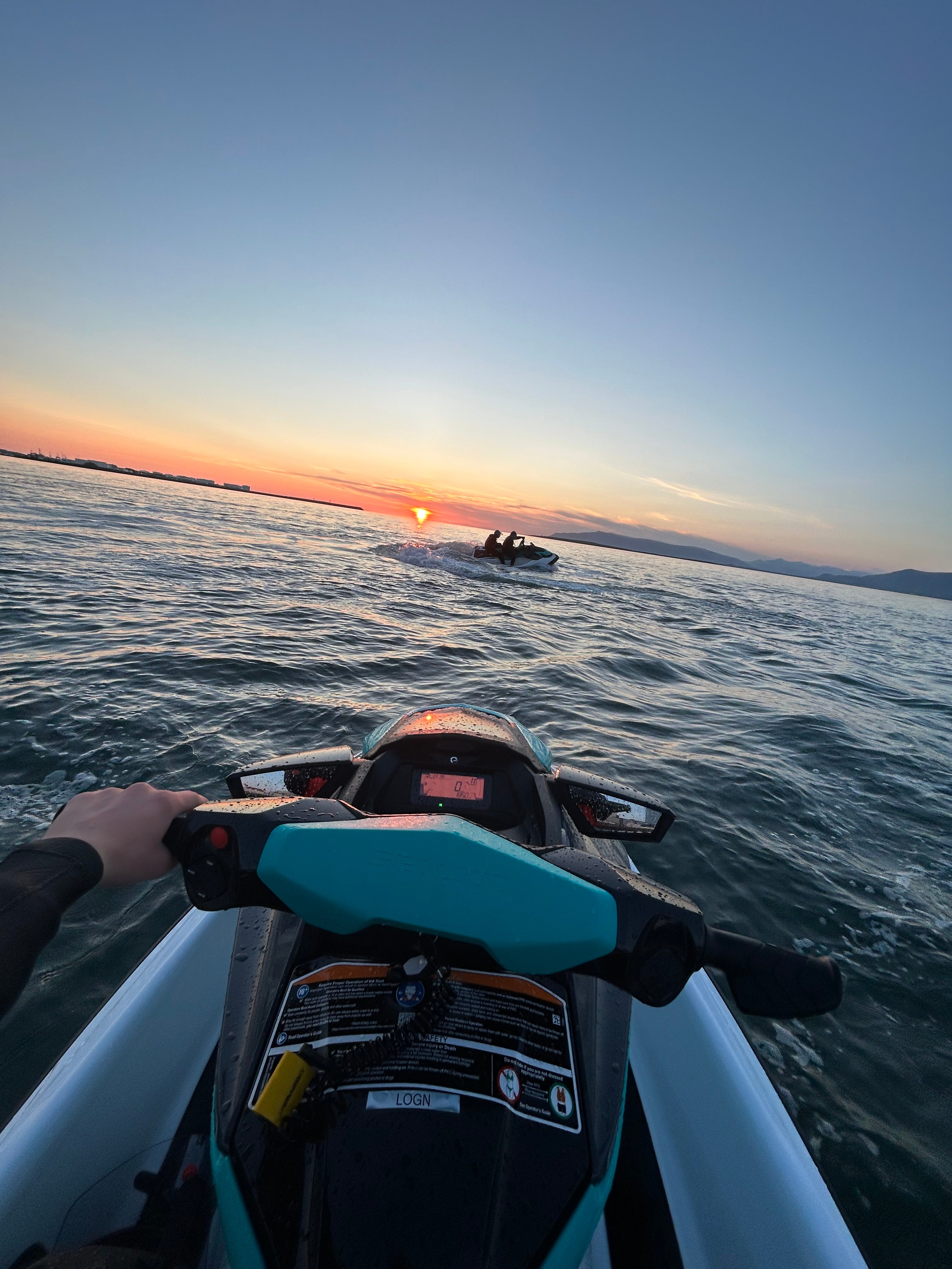 View from a jet ski riding toward the sunset on Faxafloi Bay in Reykjavik.