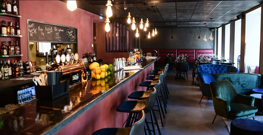 Modern bar and dining area inside Centrum Kitchen & Bar, a popular restaurant in Akureyri, Iceland.