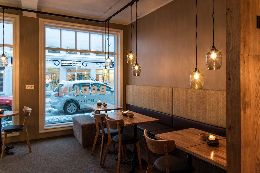 Breakfast and brunch at Cafe Berlin in Akureyri, served in a stylish, warmly lit space with a street-facing window.