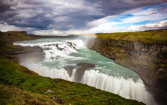 Gullfoss waterfall, also known as the Golden falls, is a stunning, must-visit Golden Circle attraction on a bend in the Hvita river.