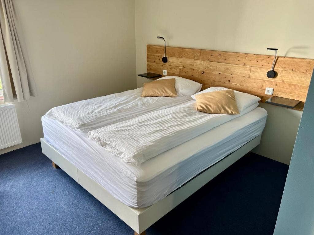 The twin room at Hotel Natur has a large double bed, with a private bathroom.
