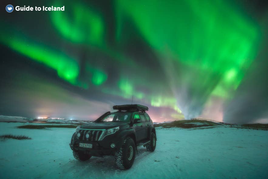 Rental car under Iceland's northern lights on a Golden Circle road trip