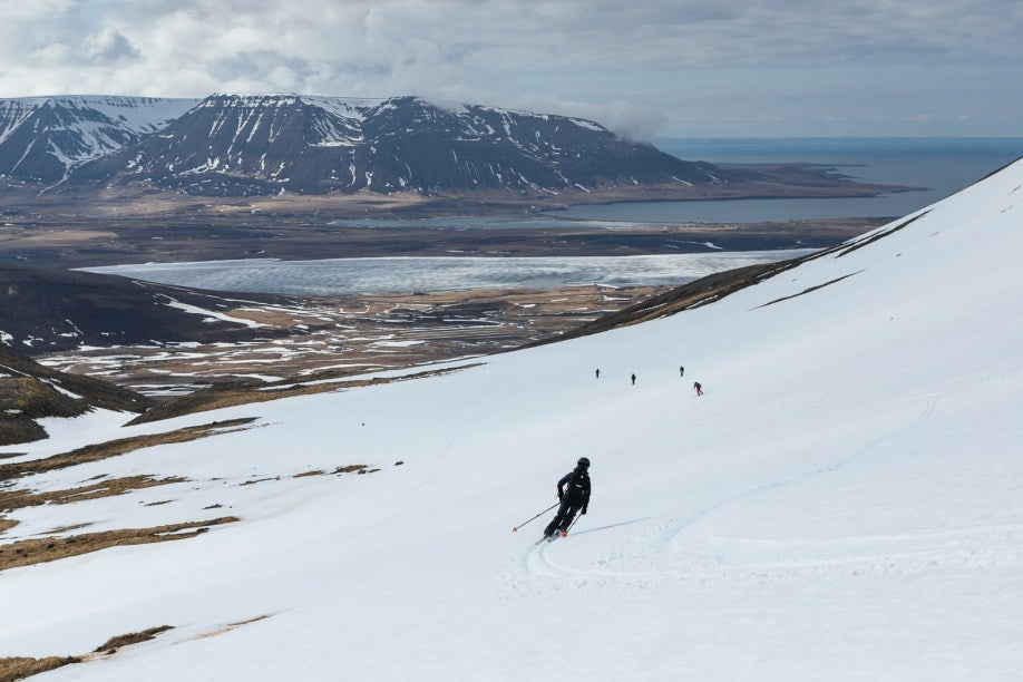 Skier following a group of skiers in North Iceland.