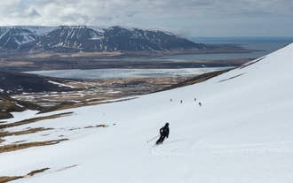 Skier following a group of skiers in North Iceland.