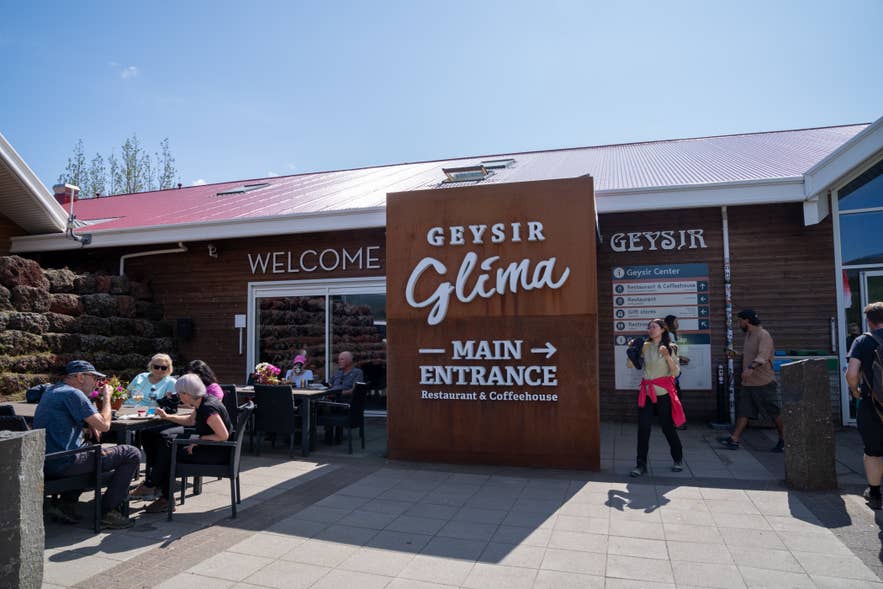 Visitors gather outside the Geysir Center restaurant and shops across from the geothermal area.