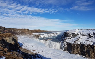 The beloved Gullfoss waterfall along the Golden Circle looks lovely surrounded by a blanket of snow.