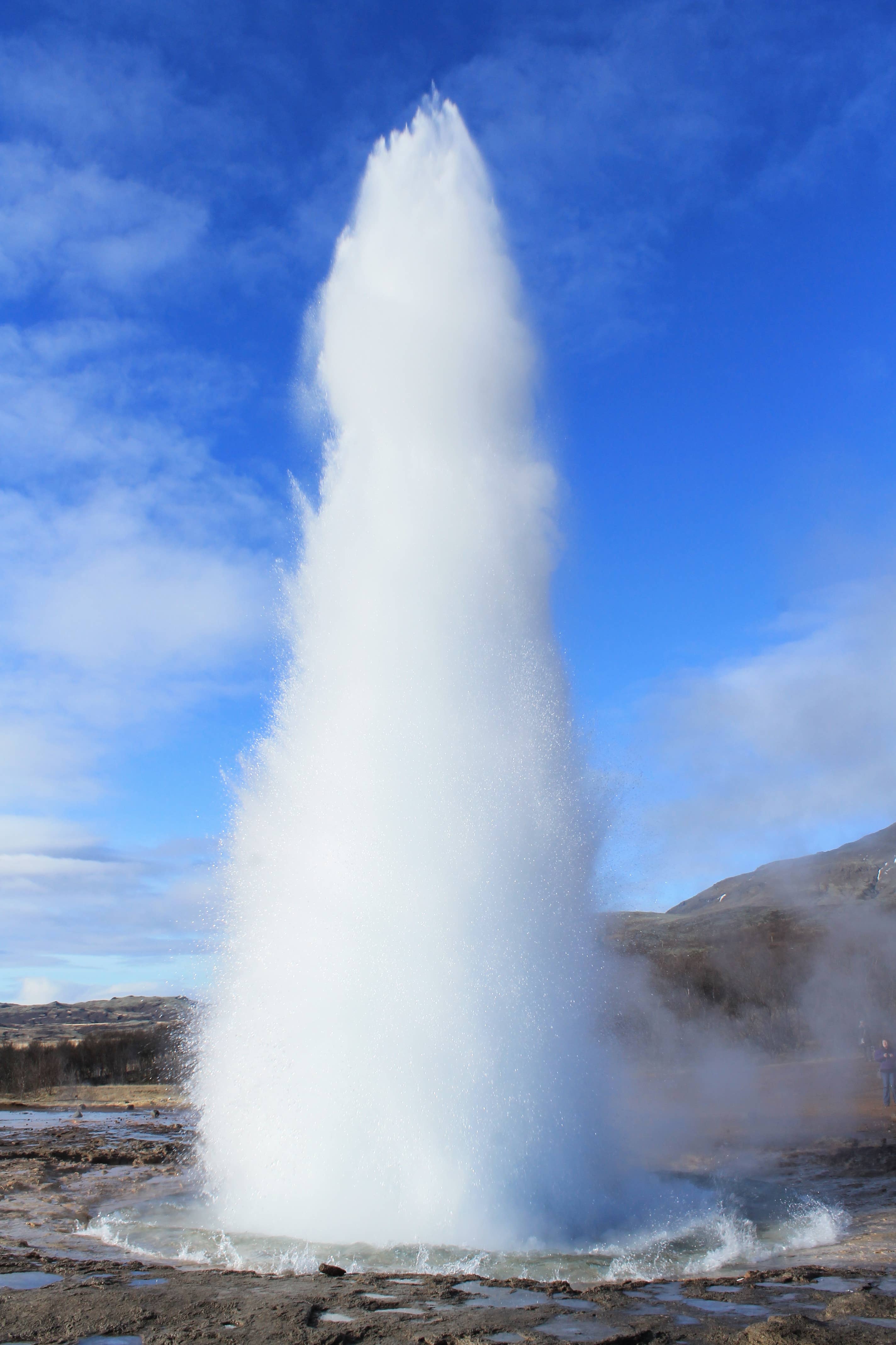 The Strokkur geyser in the Geysir geothermal area erupts.