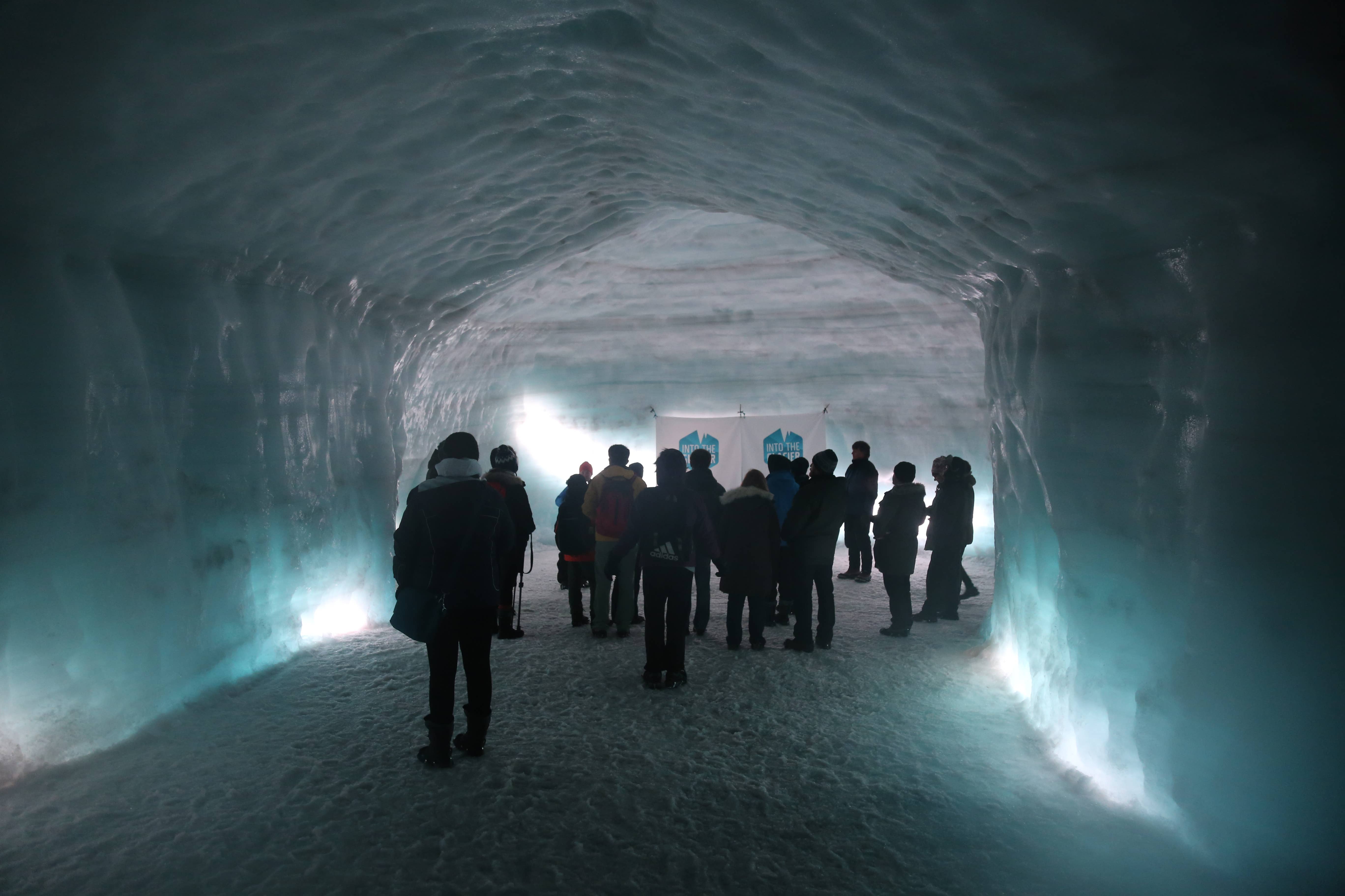 A small crowd of people inside an ice tunnel beneath the Langjokull glacier.