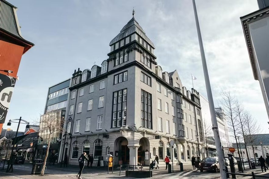 Historic Apotek building in downtown Reykjavik, Iceland, featuring classic architecture, hotel and restaurant on Austurstraeti street.