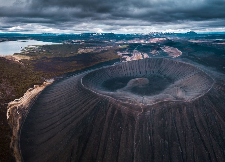 Aerial view of Hverfell (Hverfjall) tephra crater near Lake Myvatn in North Iceland, showcasing volcanic landscape under dramatic cloudy skies