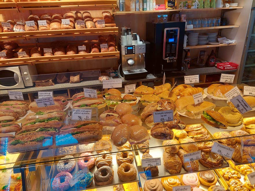 A glass bread stand containing varieties of freshly baked bread inside Kaffihus Bakarans in Isafjordur