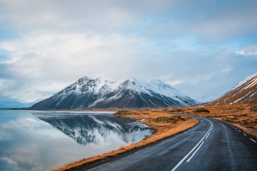 Ring Road in Iceland beside a lake with snowy volcanic mountains. Ring Road in Iceland beside a lake with snowy volcanic mountains.