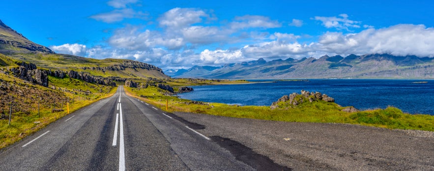 Ring Road 1 in East Iceland running along the coast with mountains in the background.