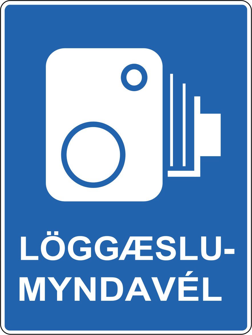 A blue rectangular sign with a white image of a speed camera and Icelandic words informing drivers of a speed enforcement area.