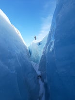 A person standing on top of the glacier during a glacier hiking tour in Iceland.