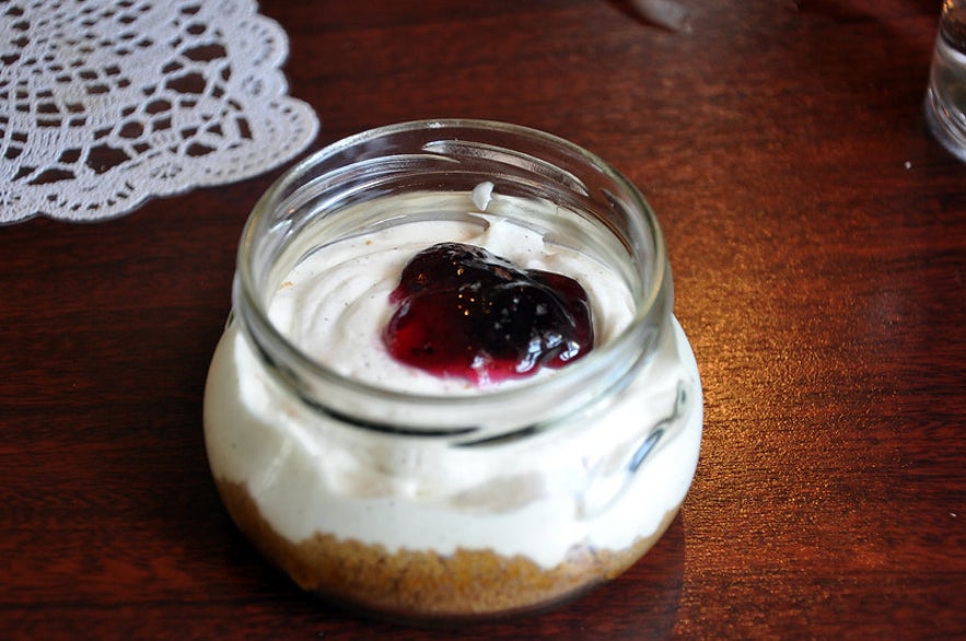 A tub of skyr topped with blueberry jam.