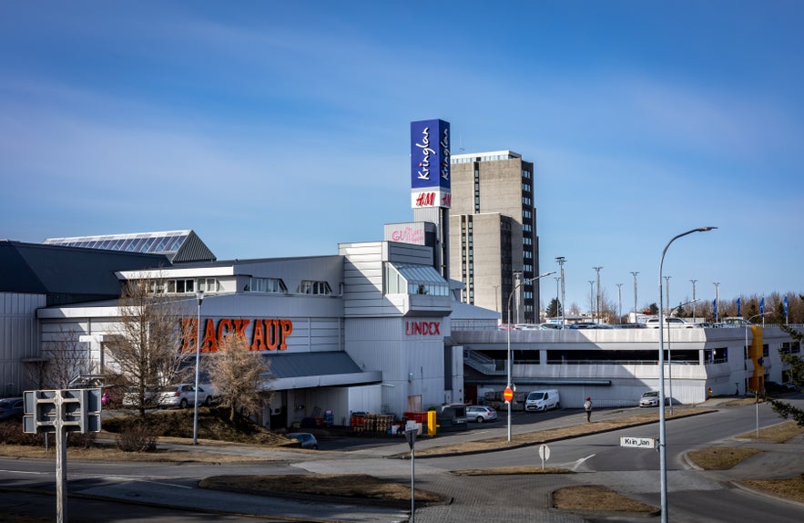 View of Kringlan shopping mall building, with visible Hagkaup, HM and Lindex logos.