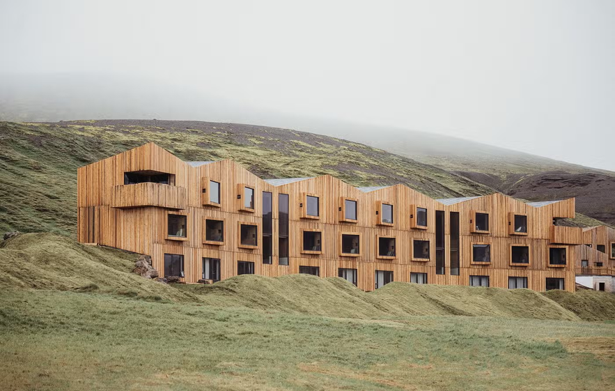 Highland Base at Kerlingarfjoll, a remote design hotel in Iceland’s Central Highlands surrounded by rugged green hills.