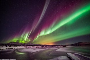 The beautiful northern lights shining in the sky above the Reykjadalur valley.