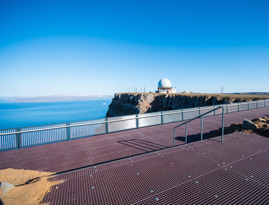Viewpoint platform at Bolafjall cliff with radar dome and ocean views in Westfjords.