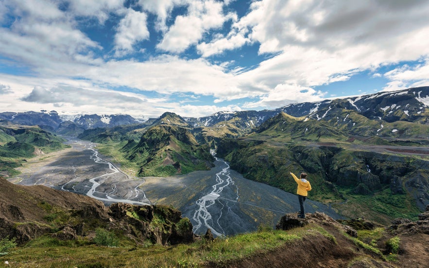 Hiker at Thorsmork viewpoint overlooking glacier rivers and mountain valleys in Iceland’s Highlands.