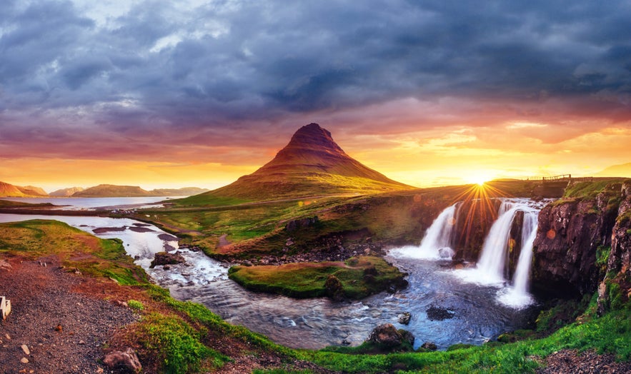 Kirkjufell mountain and Kirkjufellsfoss waterfall at sunset in West Iceland.