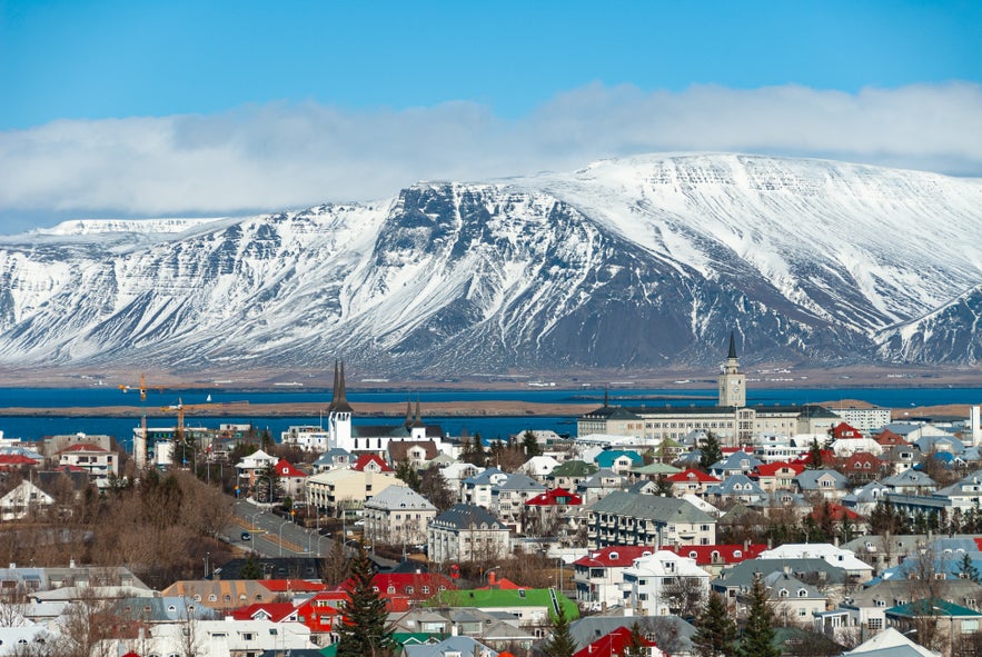 Colorful rooftops of Reykjavik with snow-covered Esja mountain in the background, Iceland.