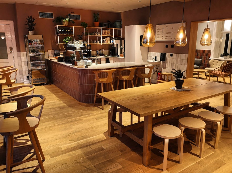 Interior of Kaffi Ó-le in Reykjavik, featuring wooden tables and a cozy minimalist design.