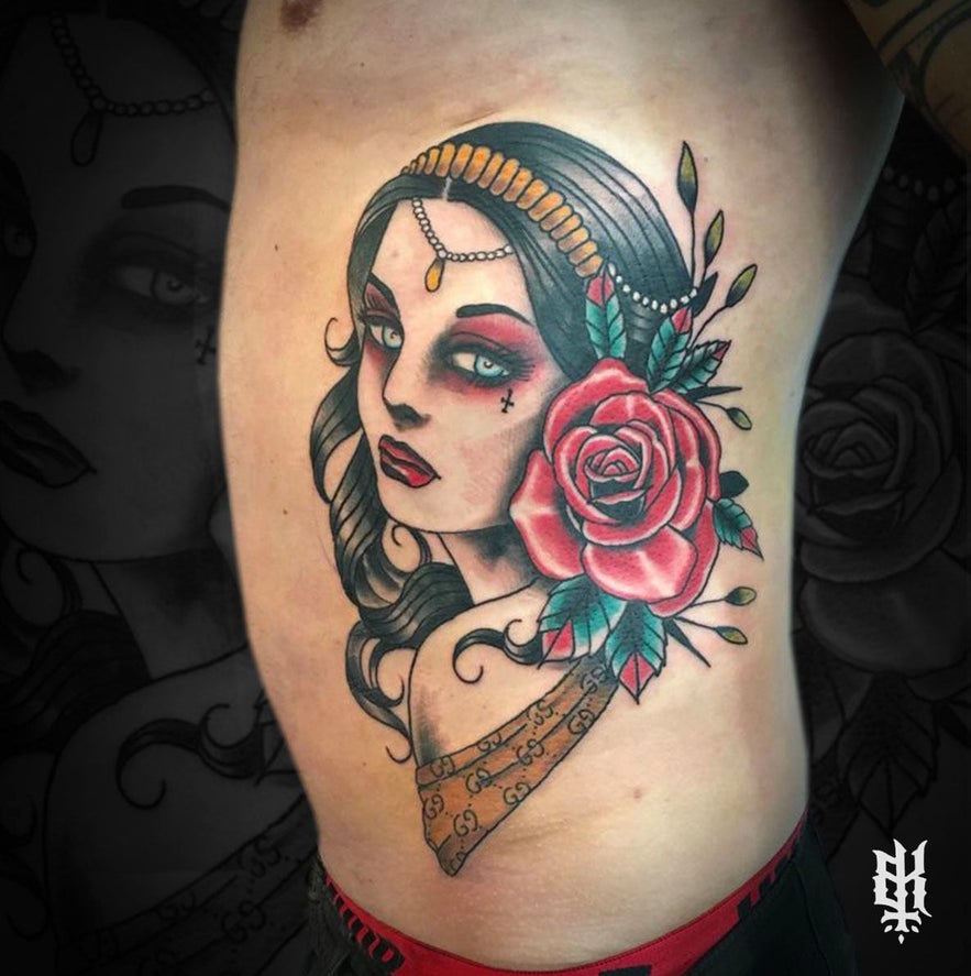 A rib tattoo of a woman, featuring delicate linework and soft shading.