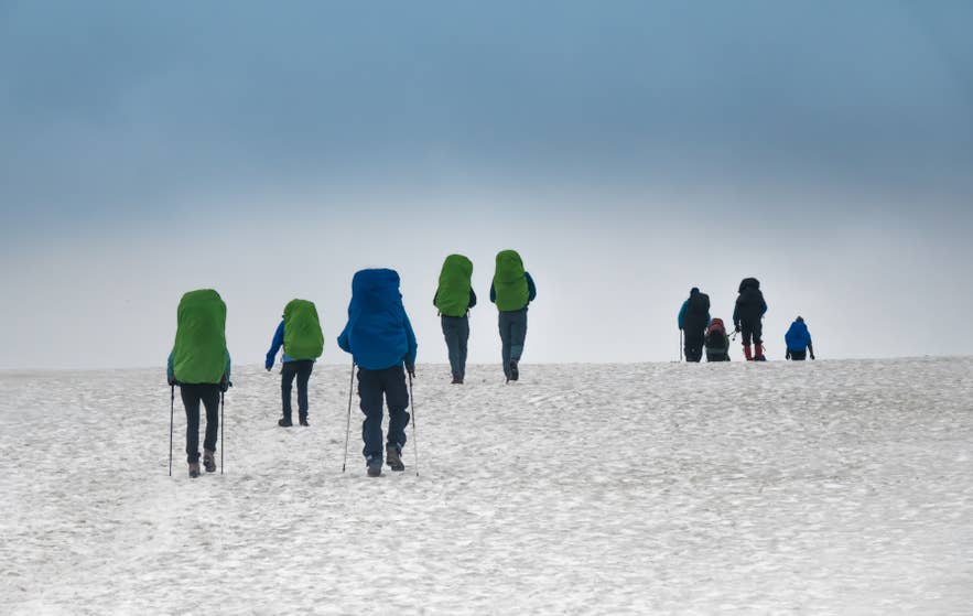 A group of hikers trekking through the Laugavegur Hiking Trail in Iceland.