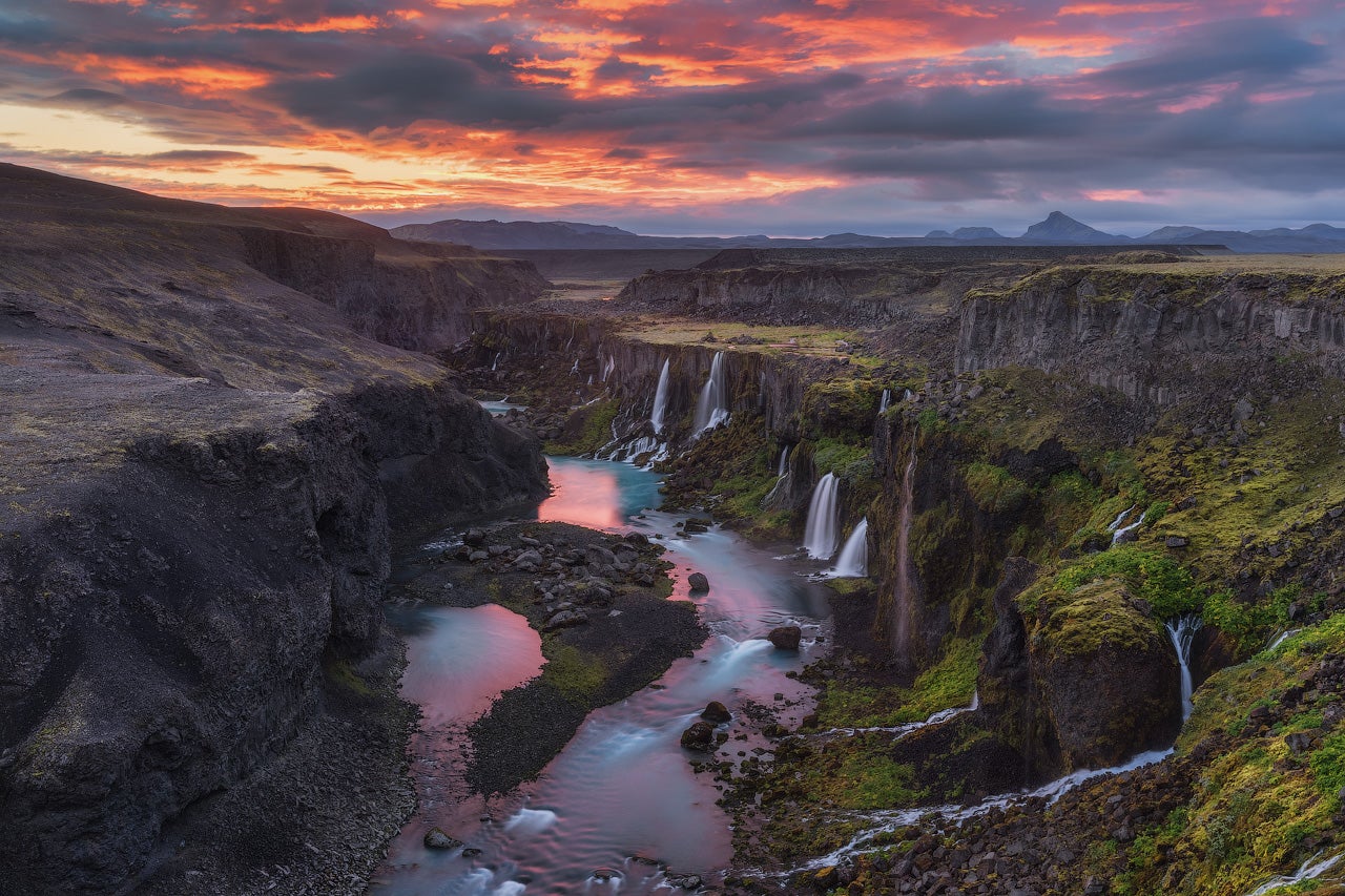 Sigoldugljufur Canyon in Iceland with moss, glacial water, and multiple small waterfalls.