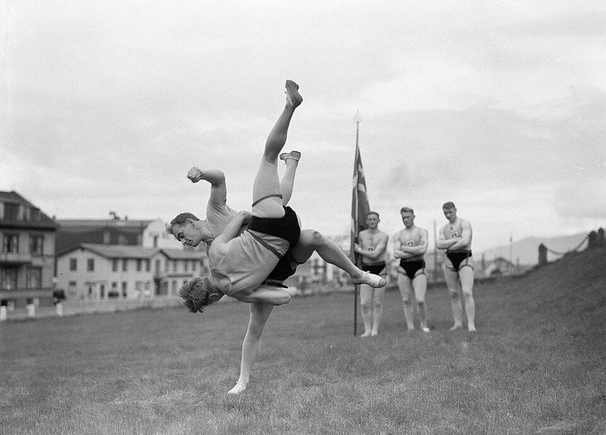 Glima wrestlers in Iceland demonstrate a powerful throw during traditional martial arts training.