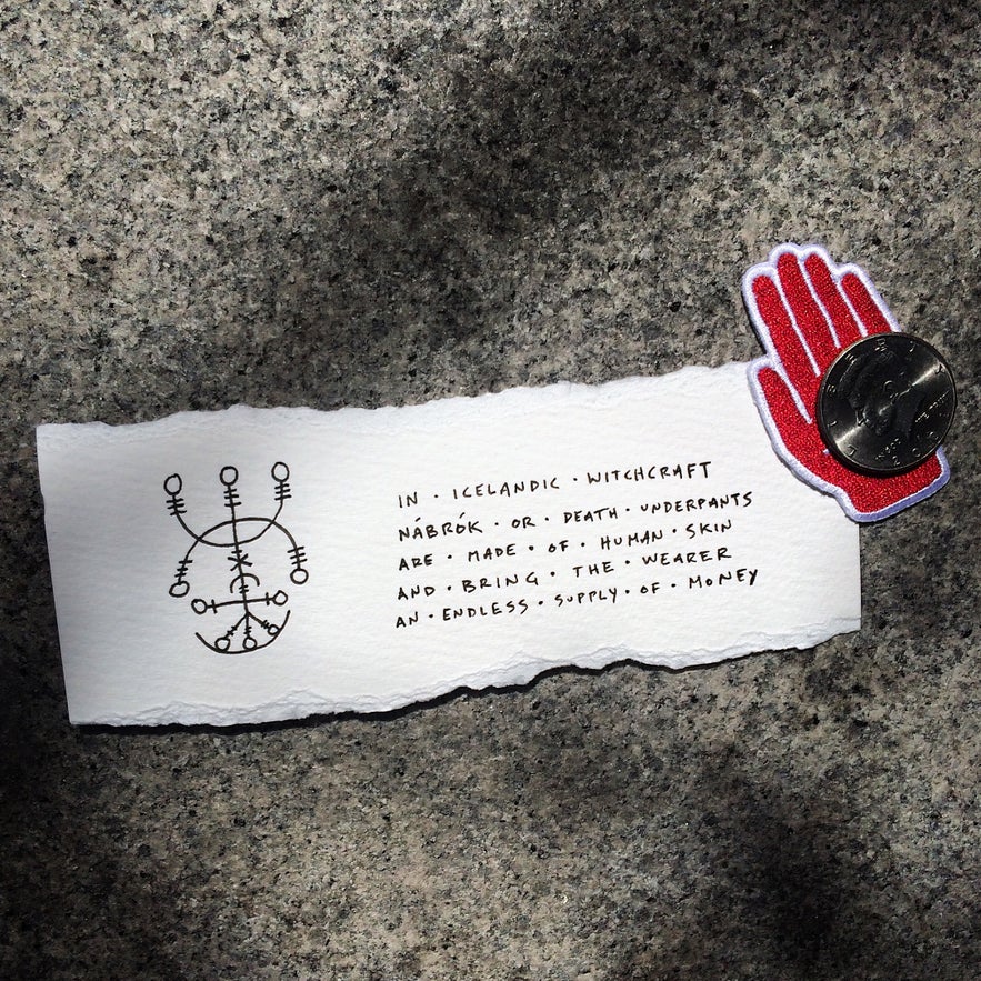 A note with a magical stave and text about Nabrok, or death underpants, from Icelandic witchcraft, pinned with a red hand magnet and coin. A note with a magical stave and text about Nabrok, or death underpants, from Icelandic witchcraft, pinned with a red hand magnet and coin.