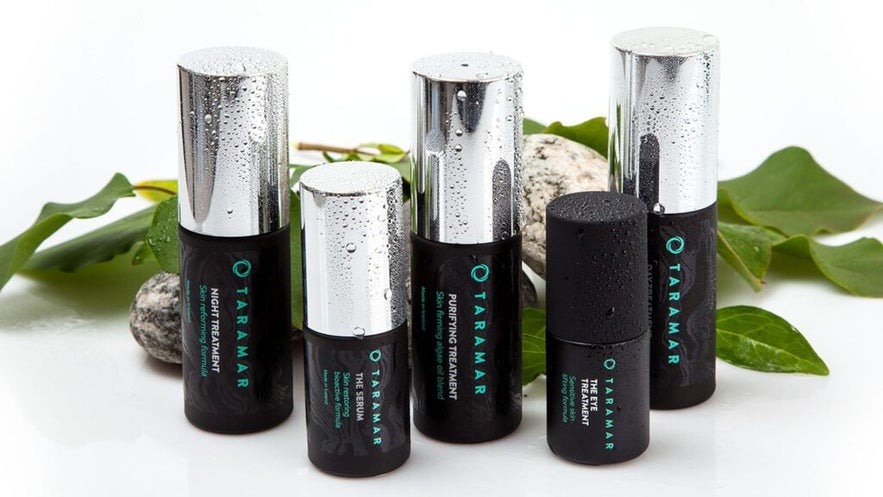 A set of wet Taramar skincare bottles, including Night Treatment, Serum, Purifying Treatment, and Eye Treatment. A set of wet Taramar skincare bottles, including Night Treatment, Serum, Purifying Treatment, and Eye Treatment.