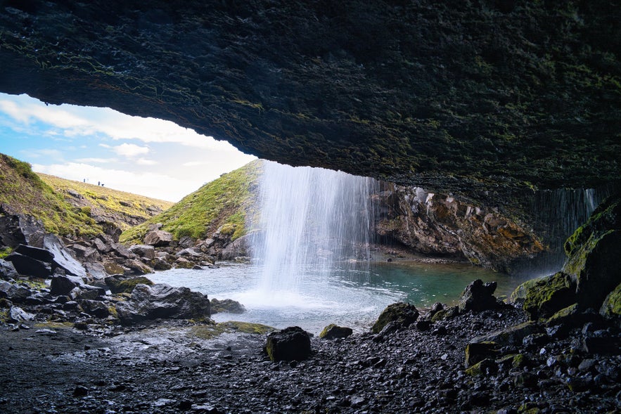 Gilsarfoss Waterfall in Iceland, viewed from inside the cave behind its cascade.